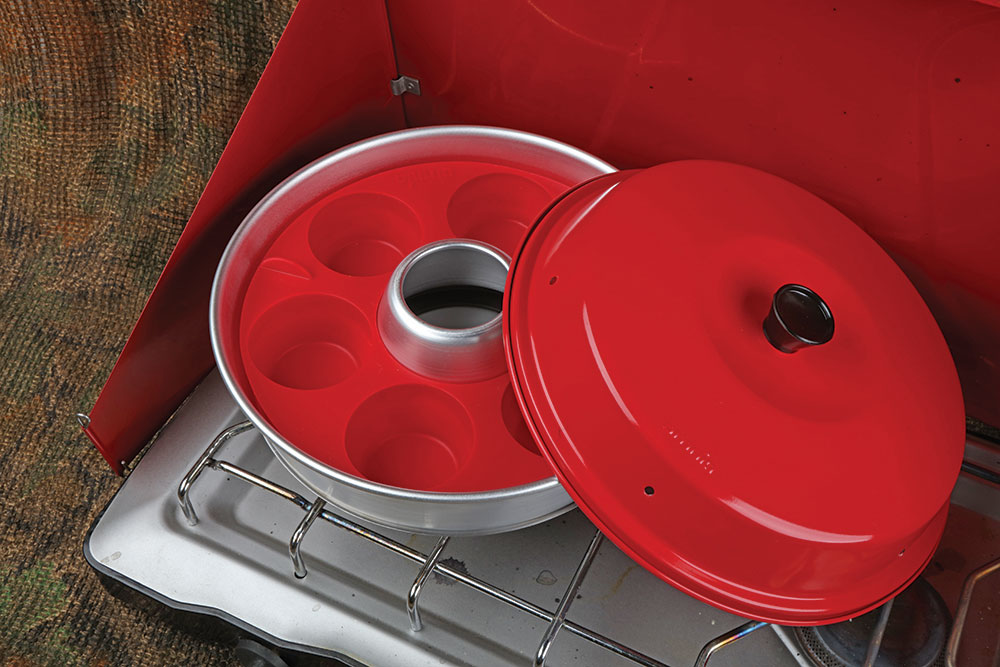 The red muffin tin sits on the stovetop.