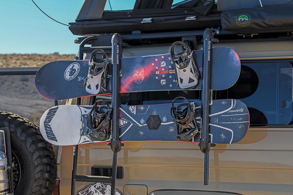 Snowboards are secured to the side of the Lexus Troopy.