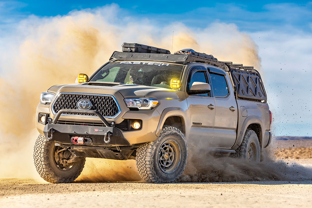 The Tacoma stops in a cloud of dust.