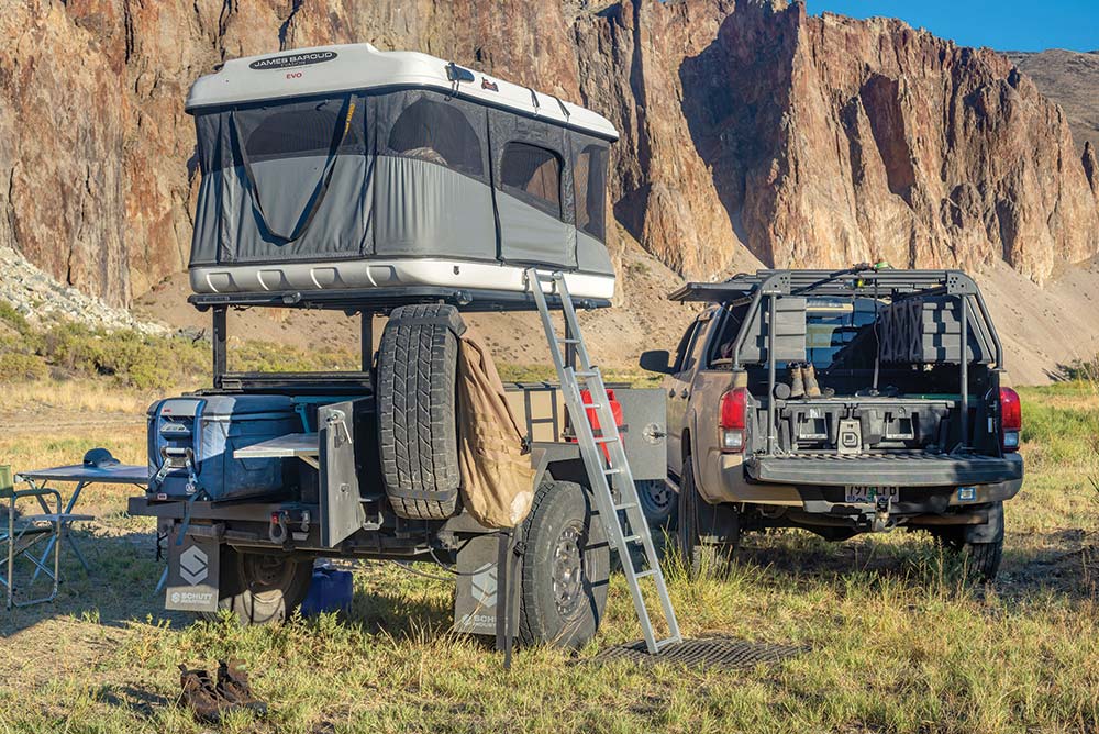 A fully set-up campsite includes the Tacoma's bed and the expanded trailer.