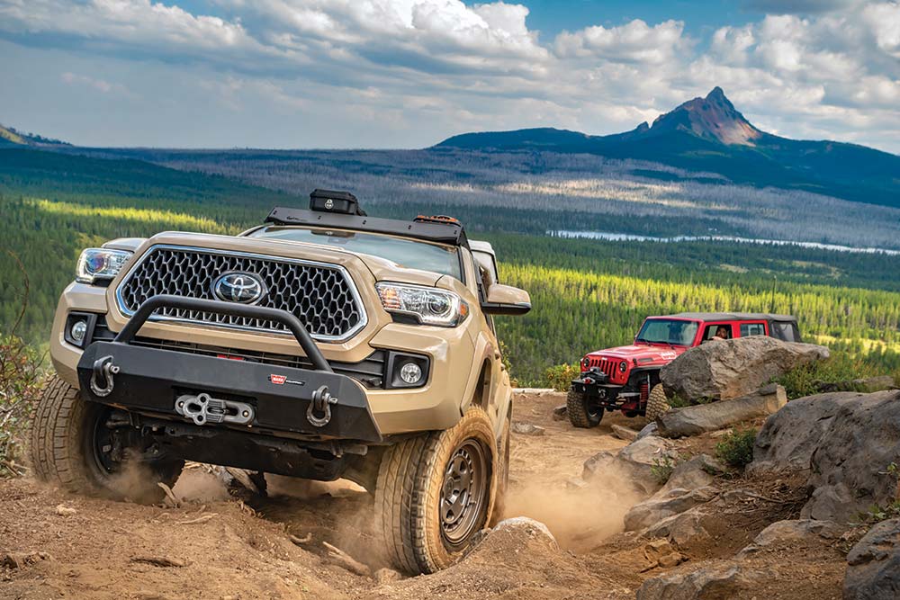 Reesor's Tacoma climbs up dusty rocks.