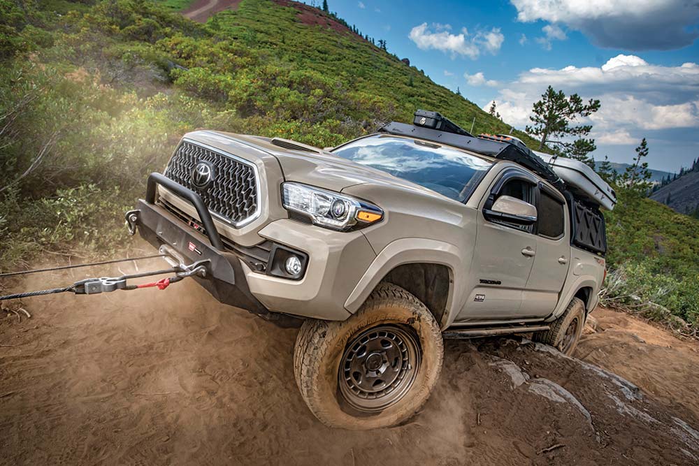 The winch pulls the Tacoma uphill.