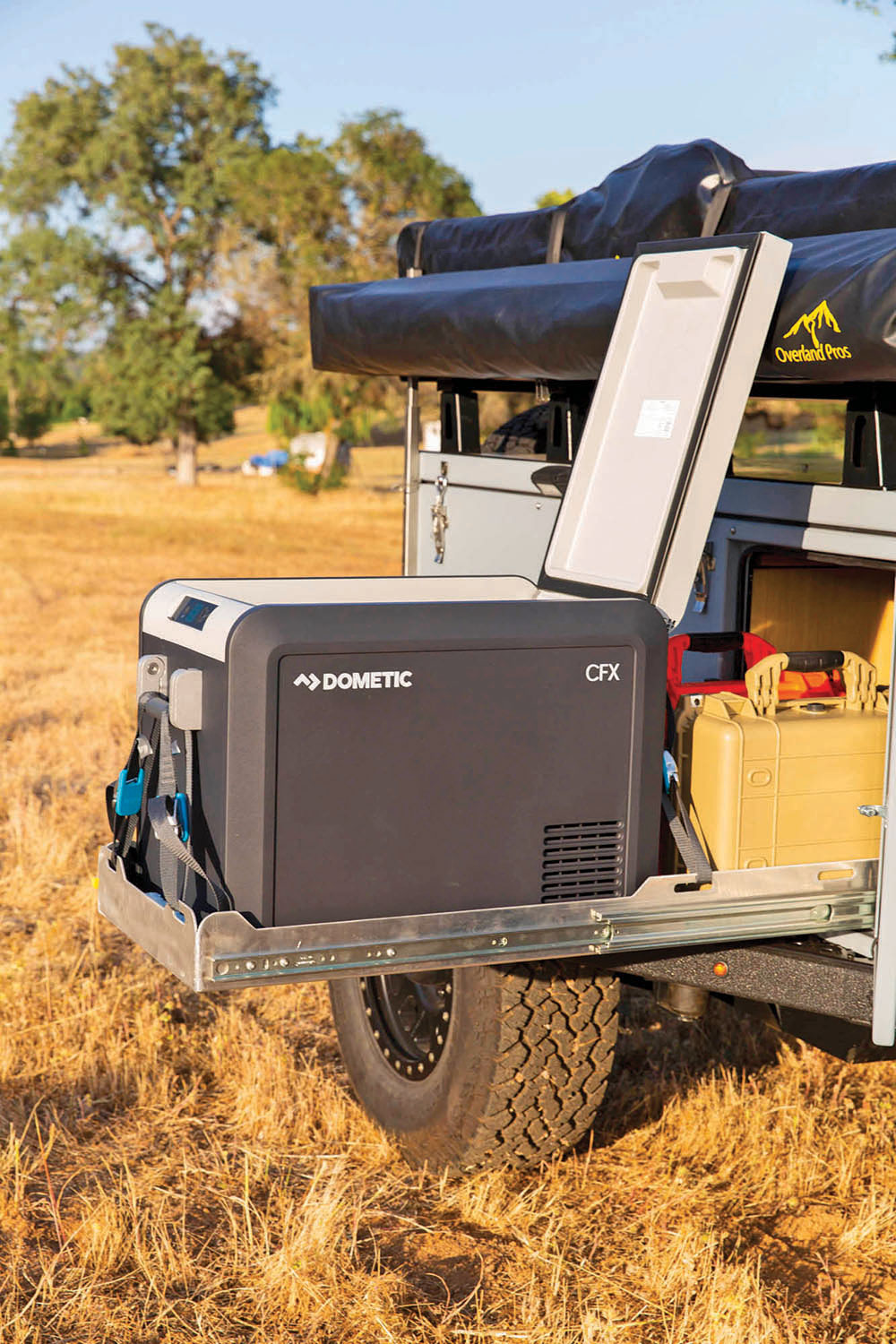 A Dometic fridge slides out of the bed of a trailer.