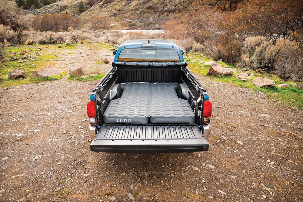 Air mattress blown up in the bed of a Toyota Tundra.