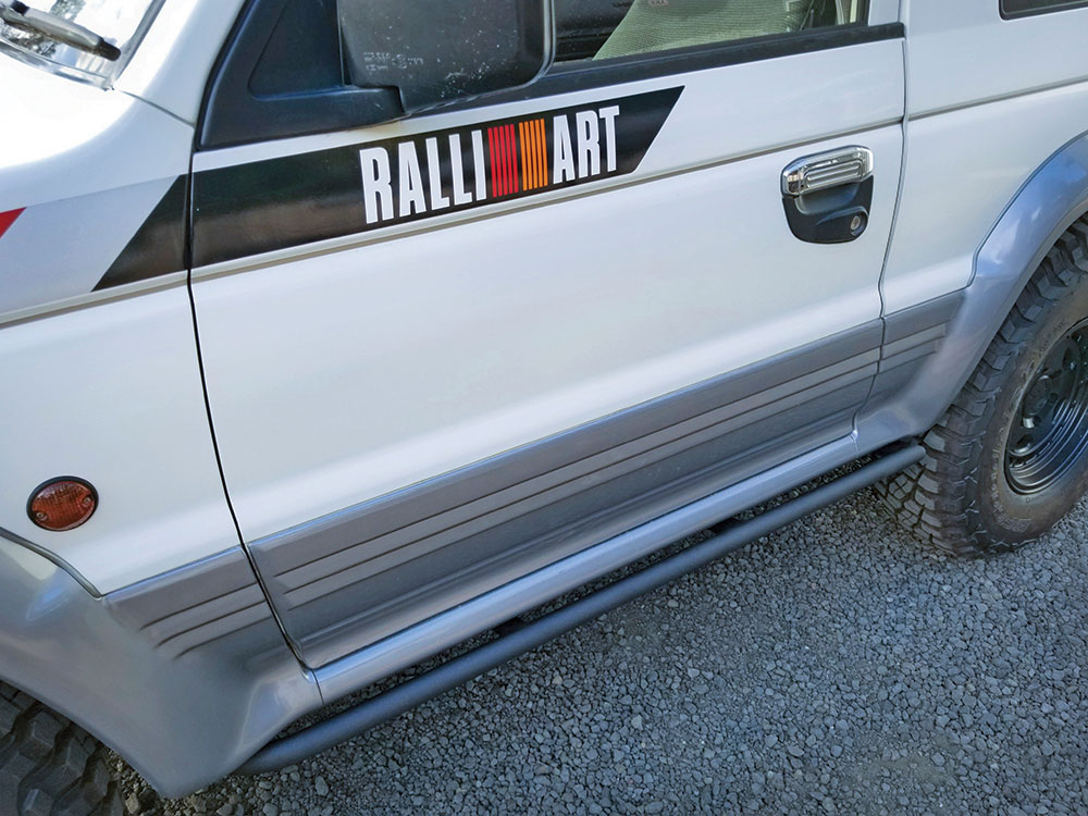 This silver vehicle features a rock slider upgrade.