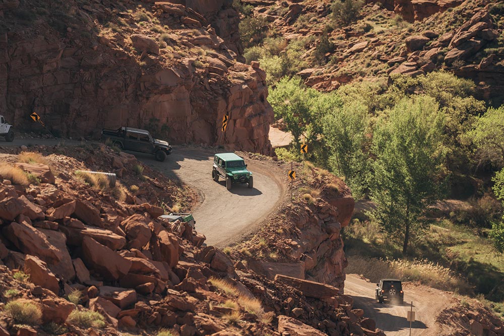 Jeeps round a corner in this aerial view from the trail.