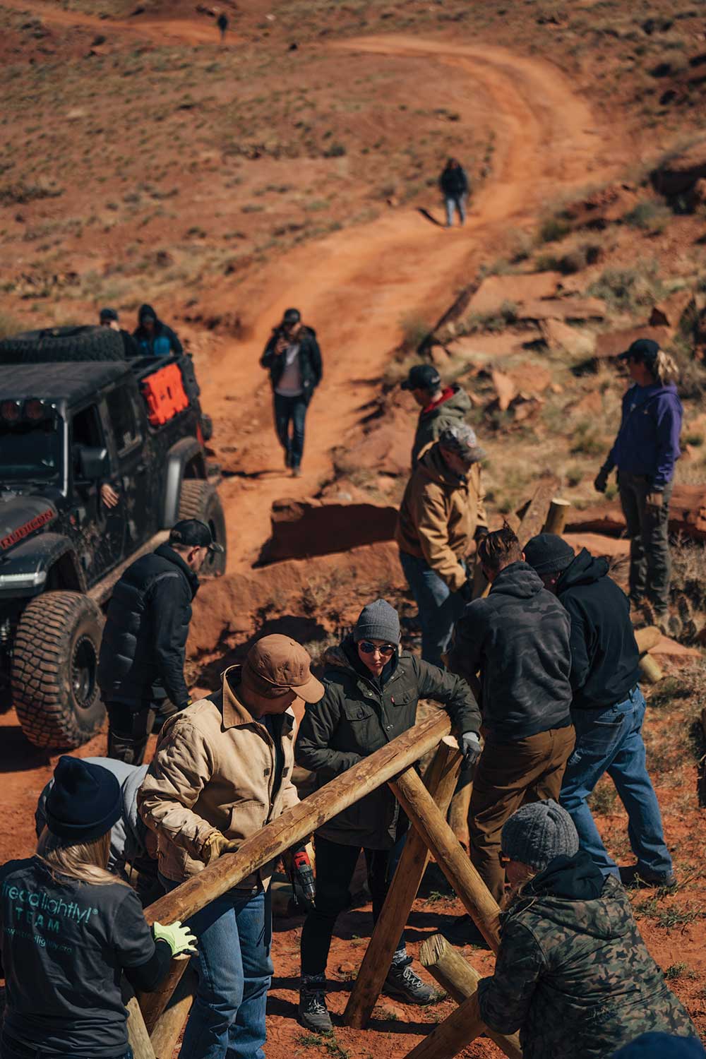 Volunteers construct a fence.