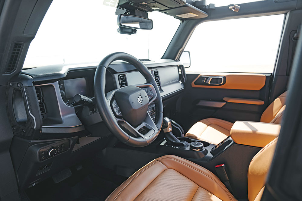 The interior of the Bronco features black technology and tan leather seats.