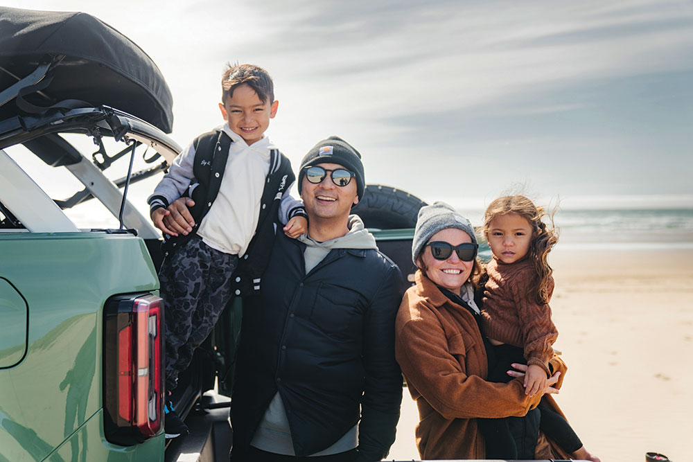 Pangilinan, his wife, and their two children pose next to the Bronco.