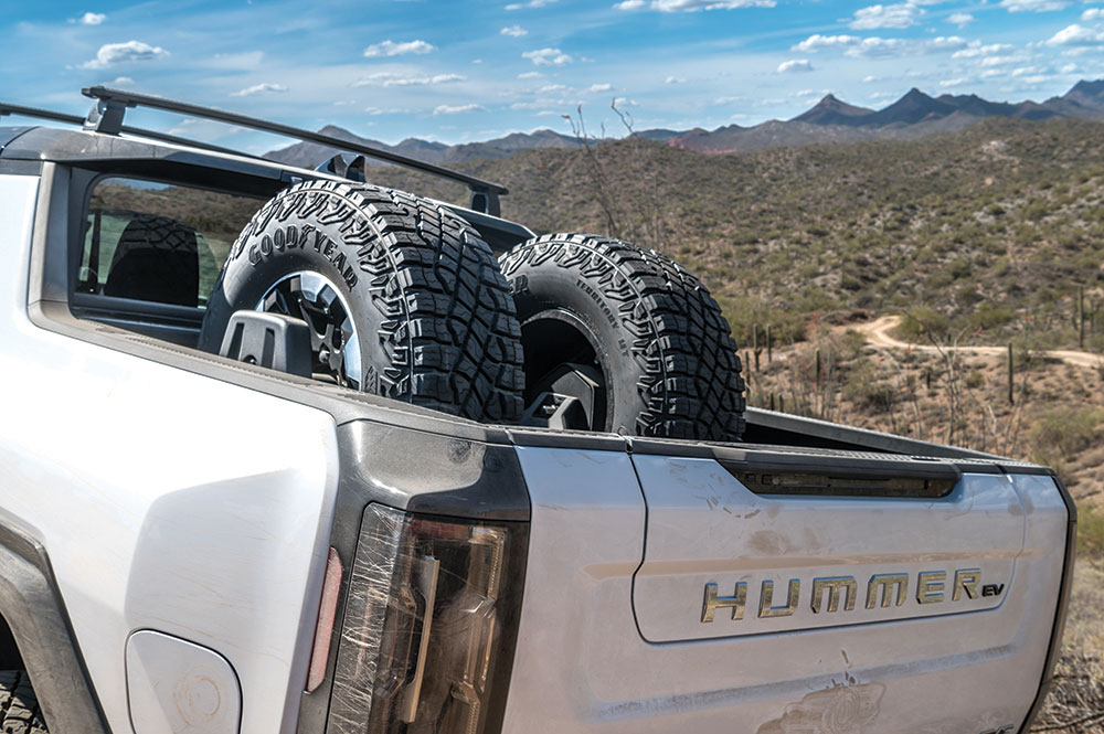 Two spare tires are secured in the bed of the Hummer.