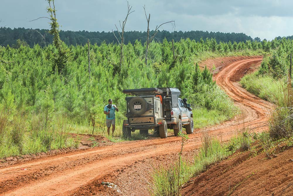 Jason Sprecht stands beside his Toyota Tacoma, capturing the moment on the trail 