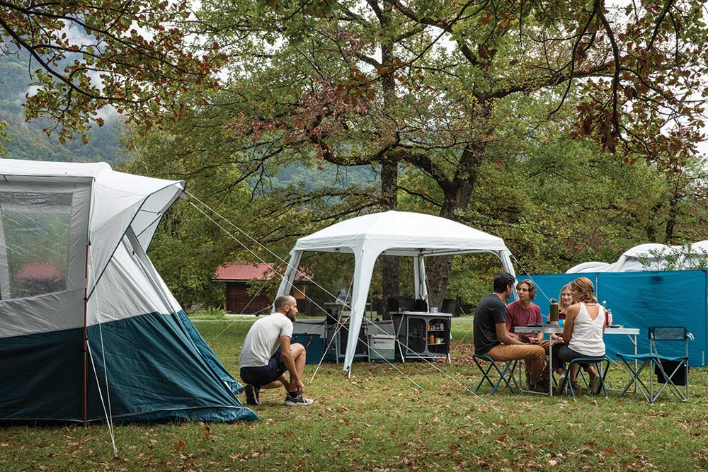 friends at a campsite with the living area camping shelter family gear 