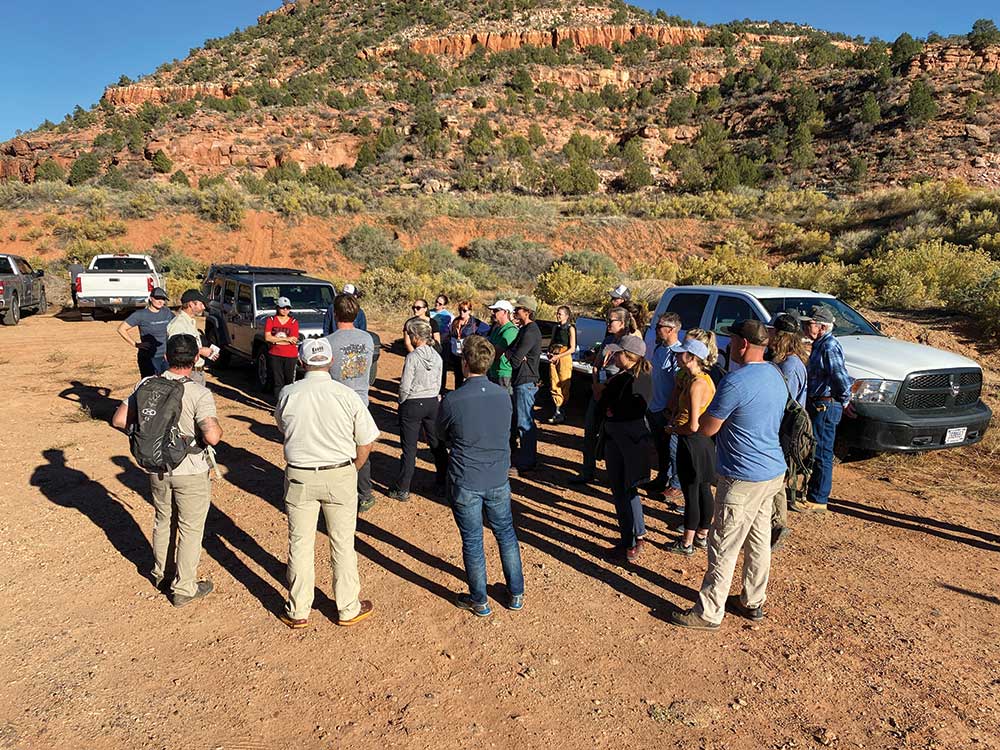 Tread Lightly! Members stand in a circle talking plans for that day's cleanup.