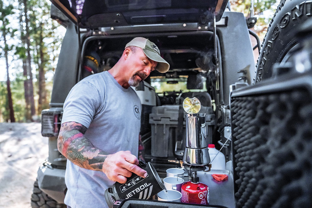Jim prepares himself some coffee at the back of the flagship Ground Pounder Coffee Jeep named HQ1.