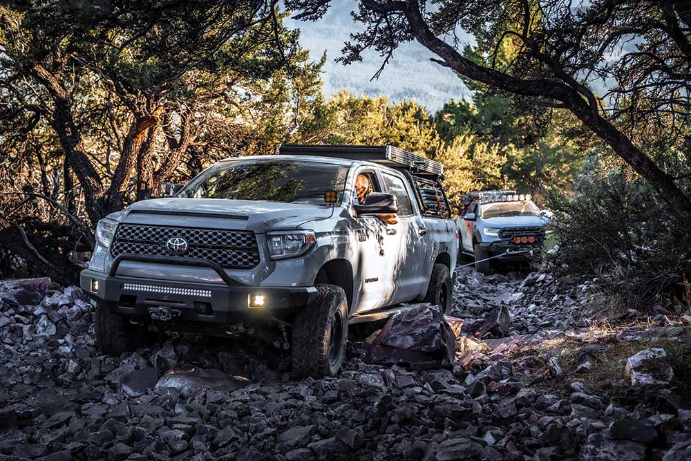 Samuel pilots the Tundra over gravelly gray rock terrain.