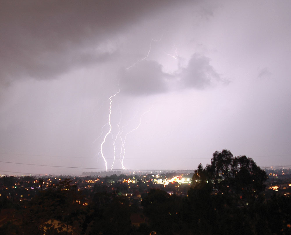 A lightning strike turns the sky light purple.