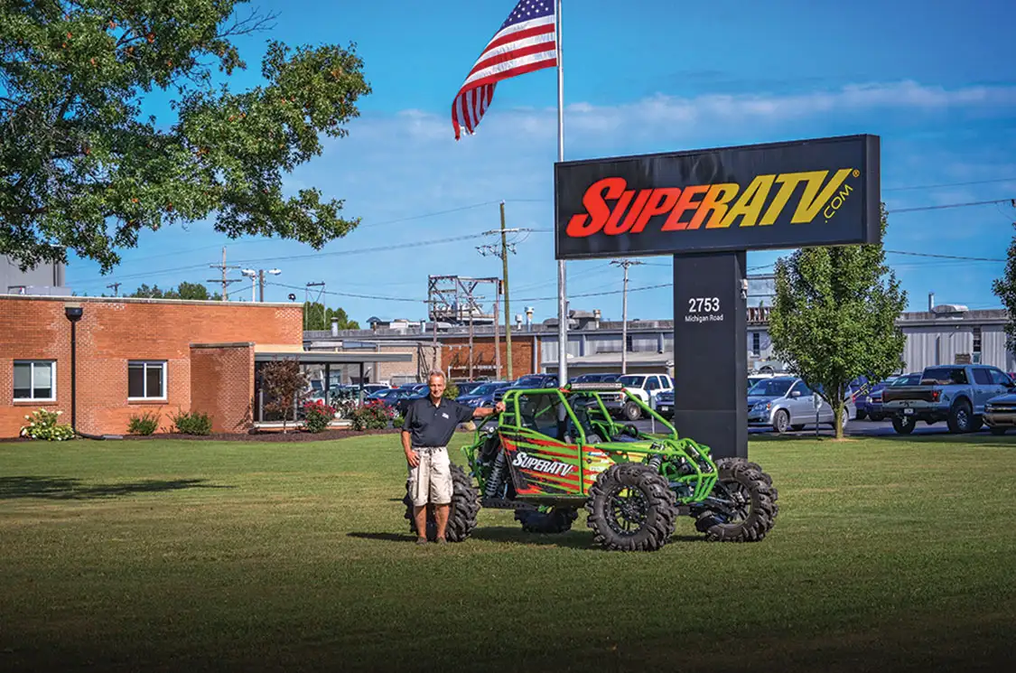Harold Hunt stands next to a UTV in front of SuperATV’s headquarters in Madison