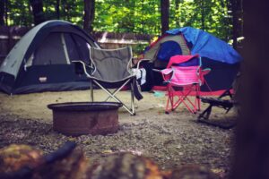 A campsite with two tents and a firepit