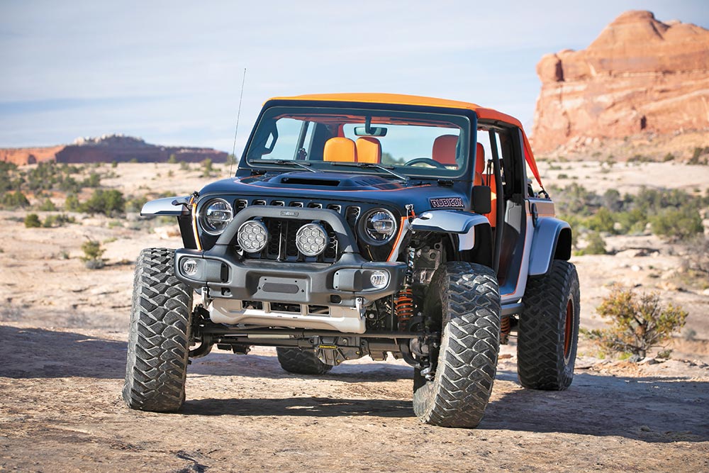 Parked in the desert, the features of Bob that are most prominent, like its lights and large tires, are showcased.