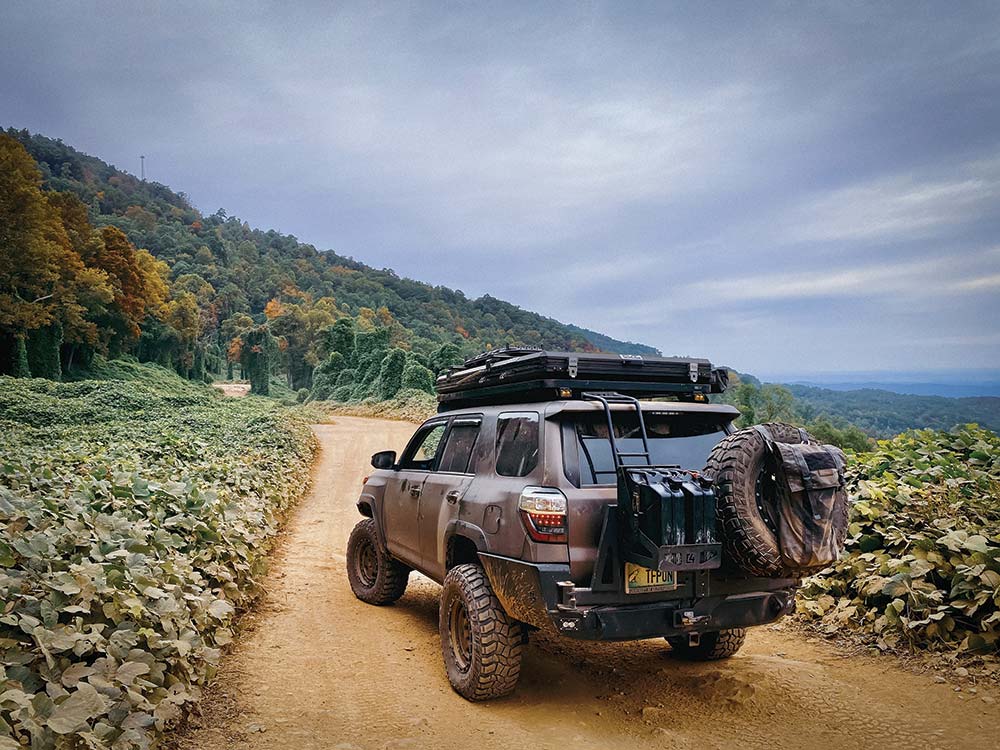 4runner on a mountain road with rooftop tent