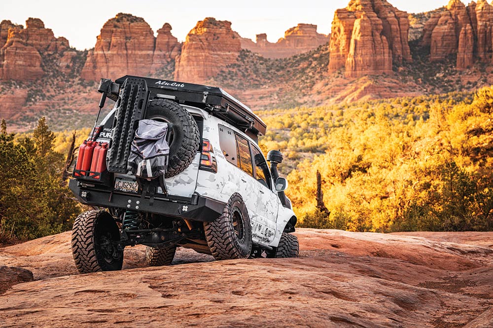 The custom rear suspension of the GX470 goes to work, tipping out the wheels as the truck maneuvers over rocks.