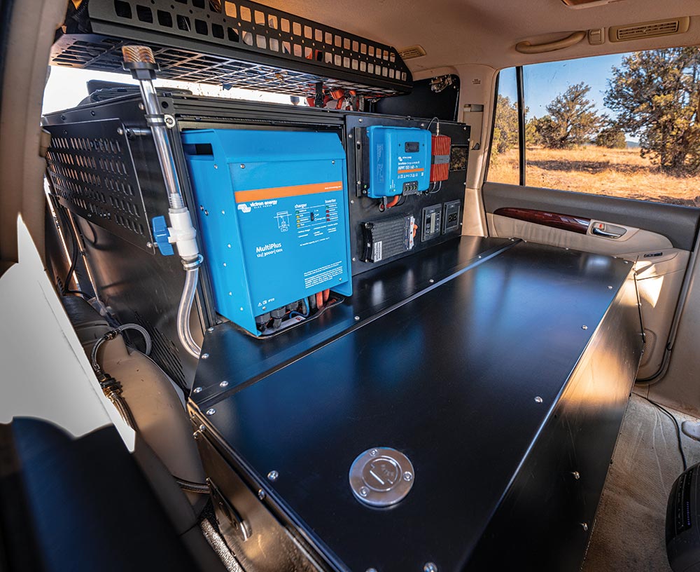 A full electrical panel with all solar charging, inverter, and battery management system devices are mounted in the trunk.