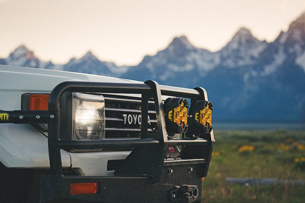 The front grille of the world traveling Troopy features yellow lights and a bull bar.