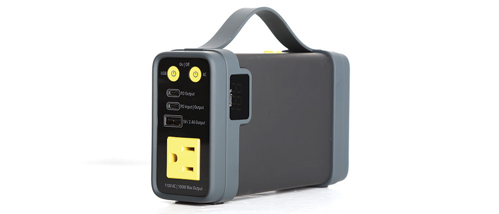 Small rectangular battery for bug out rigs with yellow accent colors on the output plugs.