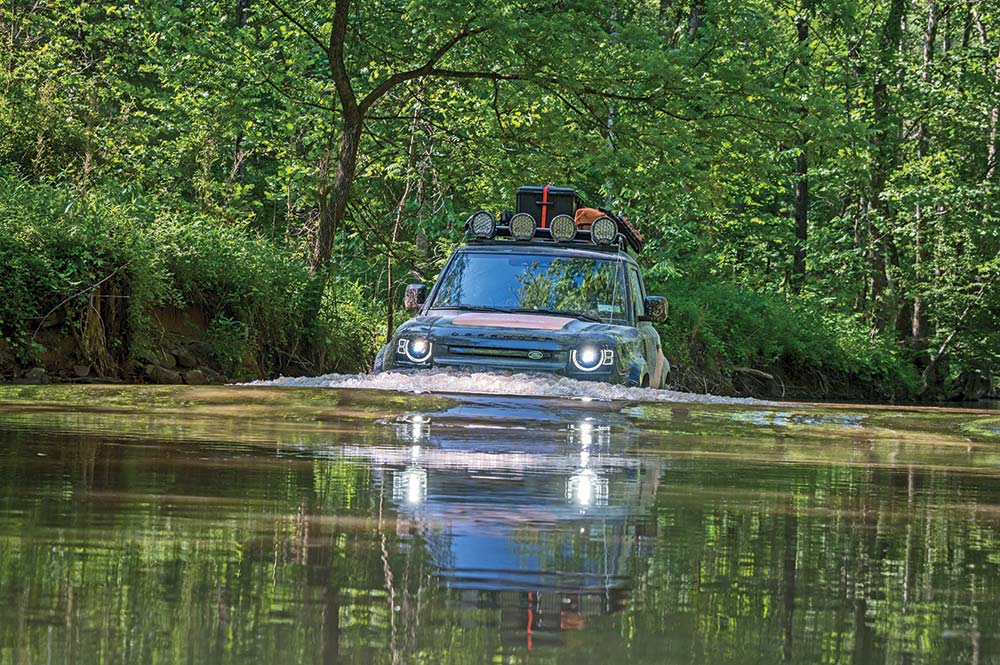 Land Rover drives through standing water 