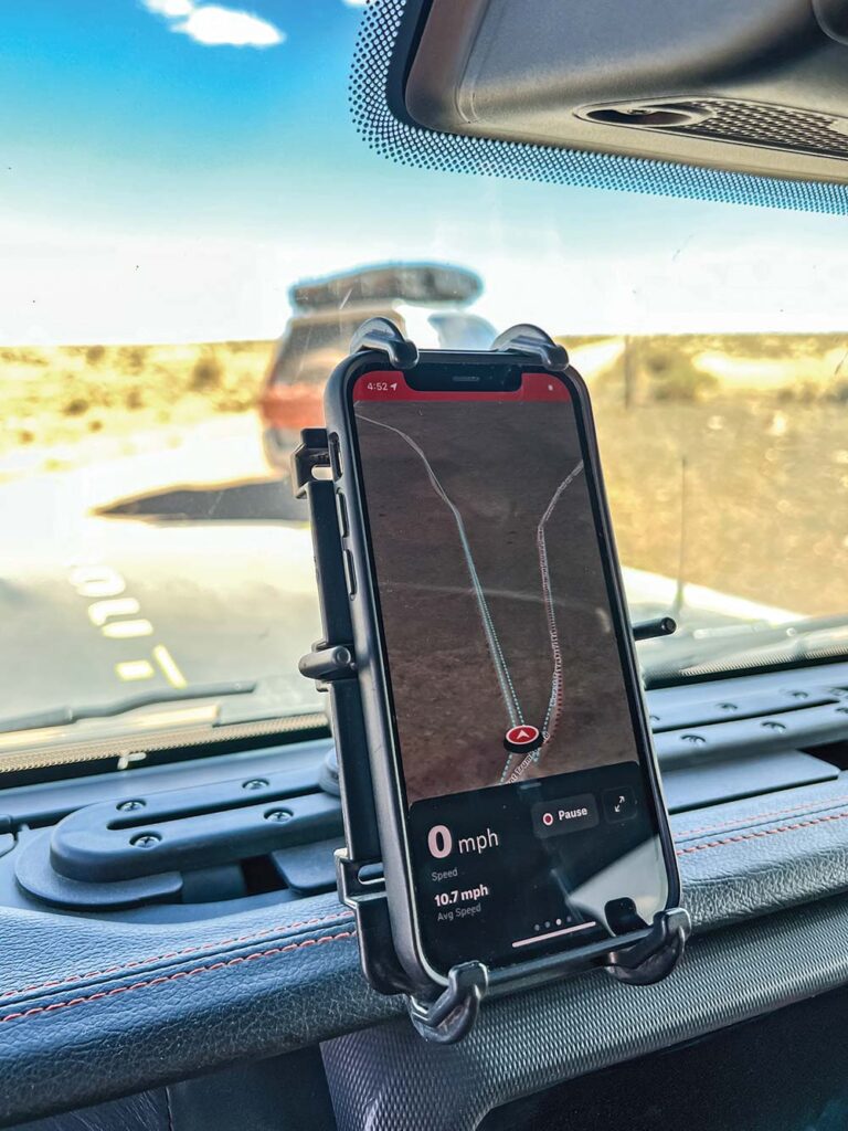 An iPhone in an overlanding rig dash mount displays maps of the Grand Canyon.