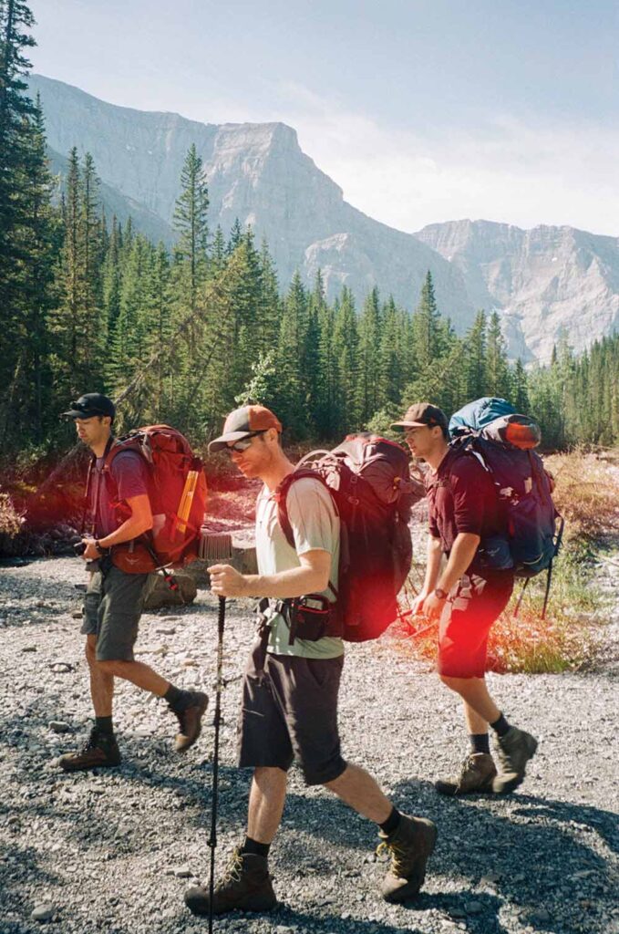 three people hiking in mountains