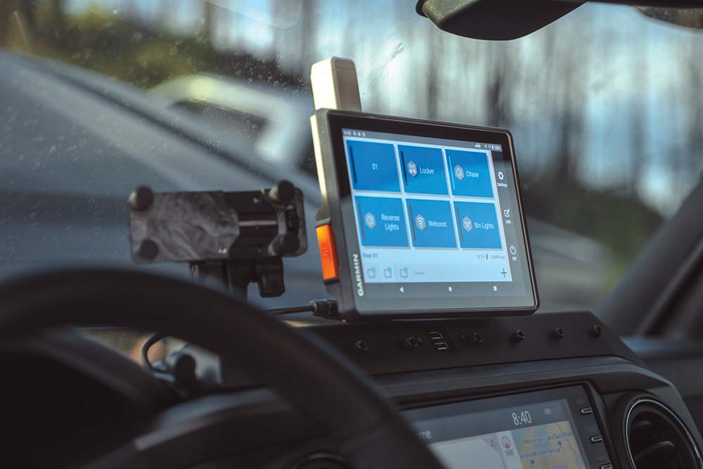 A small tablet mounted to the dash displays navigation software.