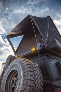 Looking up from the rear mounted spare tire, the roof top tent adds extra space to the vehicle.