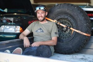 Owner Jason Spek takes a moment to relax in the bed of his Frontier at a local car show.