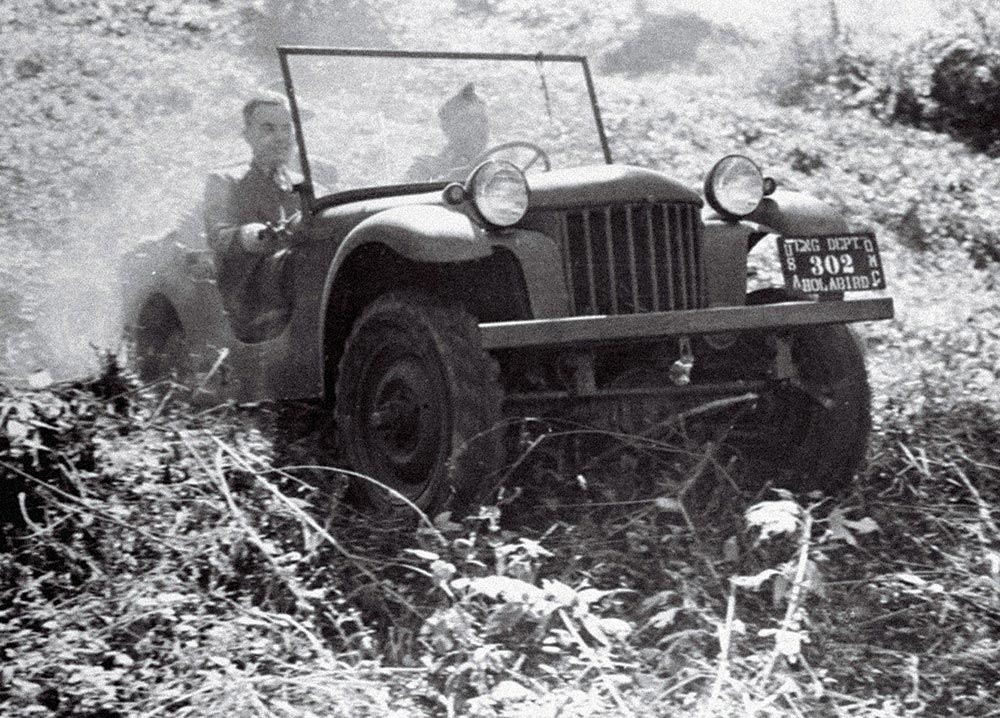 Karl Probst's plans inspried this Jeep prototype that carries two men up a plant-covered hill.