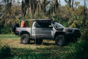 A gray Tacoma with roof awning.