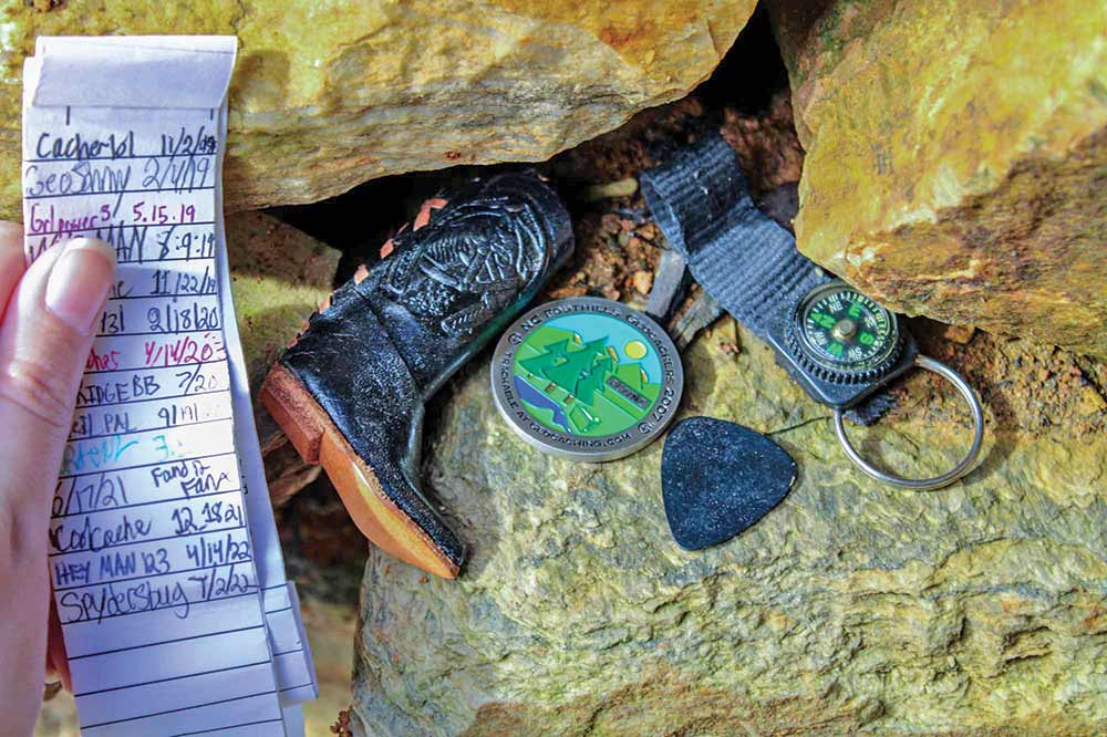 Geocaching reveals a log sheet of names and dates was crammed inside a tube with other fun cache contents.