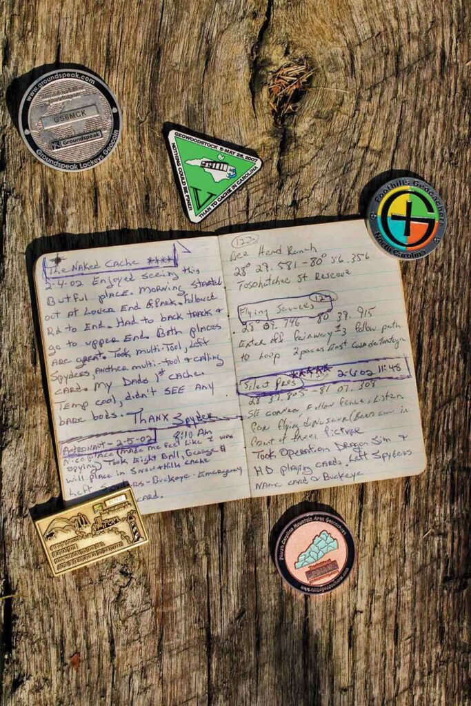 A geocacher's small notebook is filled with clues and coordinates as well as notes from the geocaching.