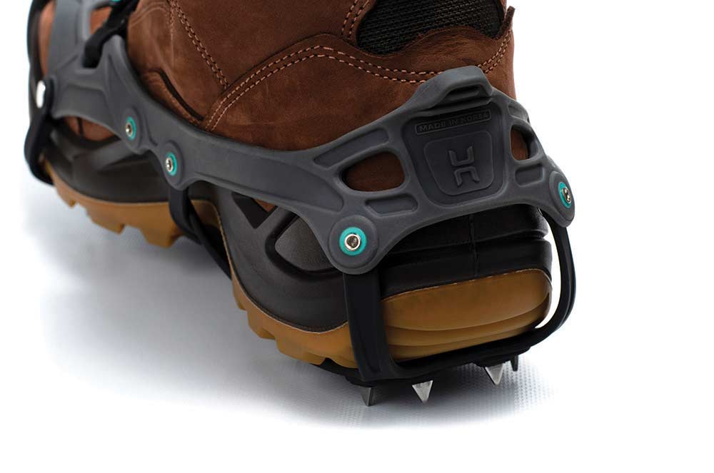The heel of the crampon features a pull tab and sharp spikes.