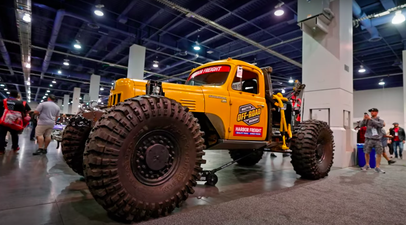 Yellow tow truck on huge tires