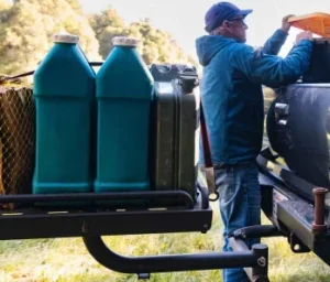 Jerry cans balance on the rear swing out platform on this 4x4 truck.