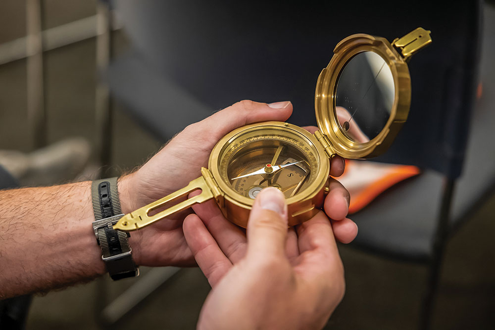 A large, heavy brass compass served as the baton for the Land Rover TReK 2022 events.