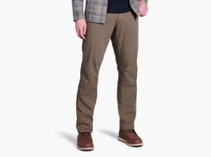 A guy models brown pants on a white background.