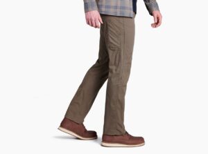 A guy models brown pants on a white background.