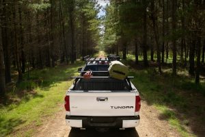 A white Toyota Tundra with Rhino Rack Reconn-Deck bars mounted across the bed.