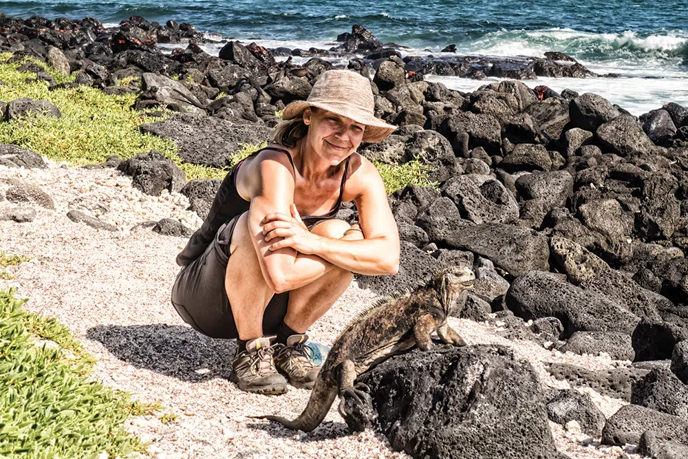 Heather with a land iguana in the Galapagos Islands