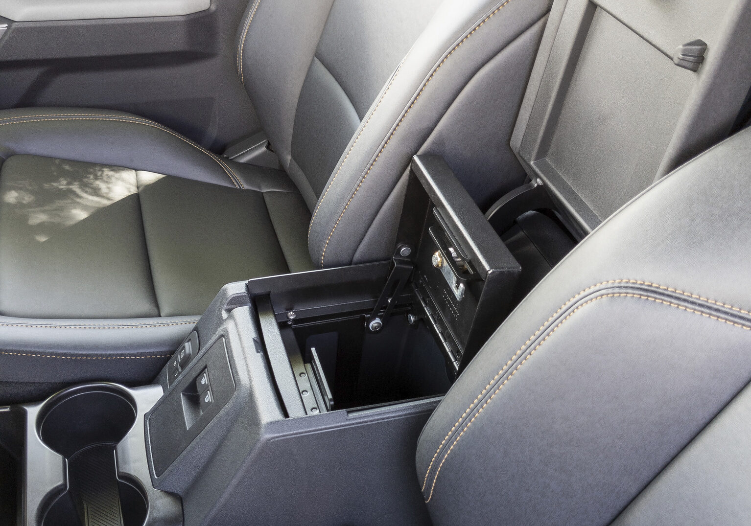 The center console opens to reveal a Tuffy center console safe in a Bronco.