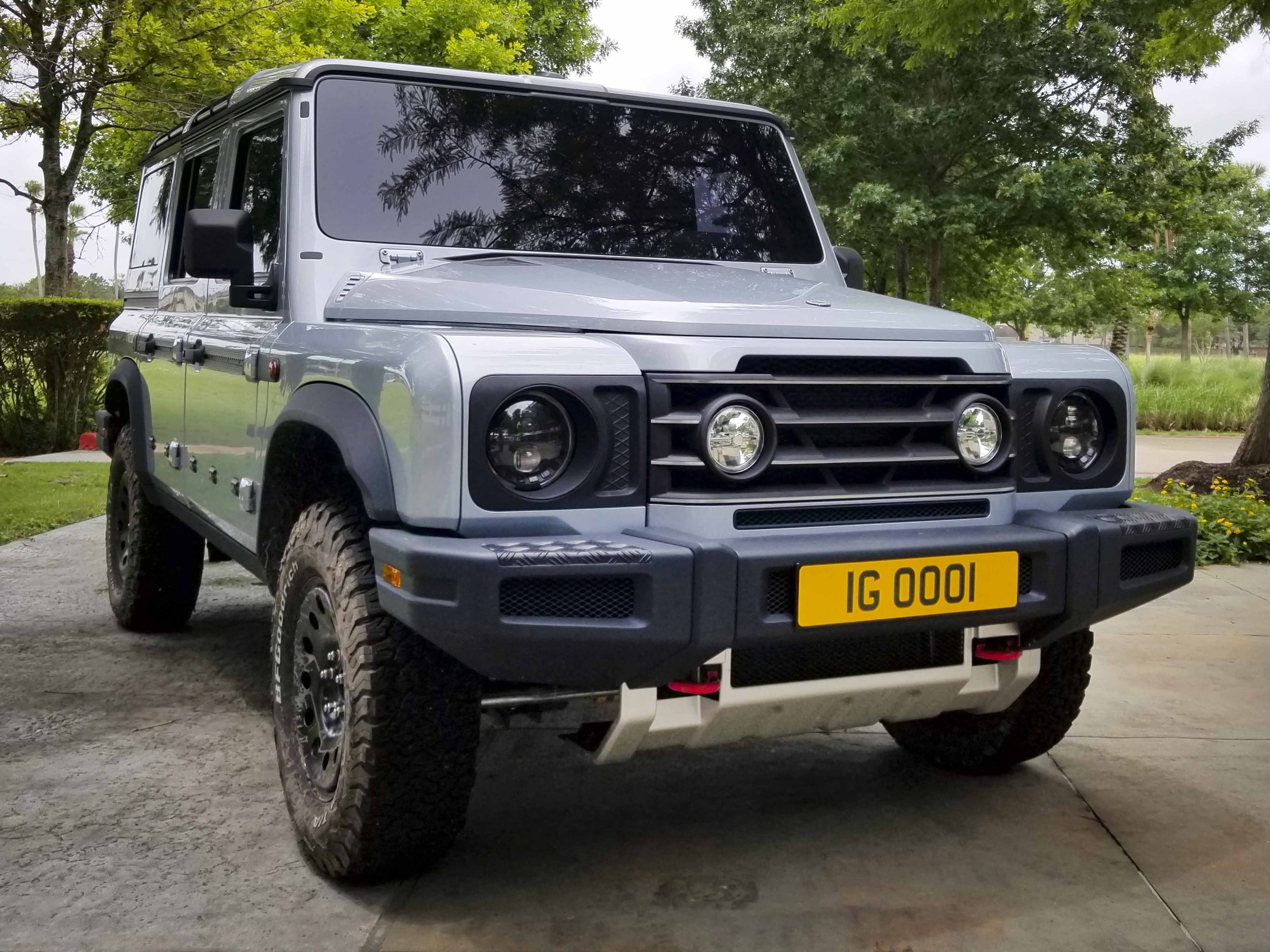 We see the front end of a silver INEOS Grenadier prototype vehicle.