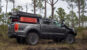 Ford Ranger with Black Rhino wheels and bed storage with Maxtrax mounted to the side.