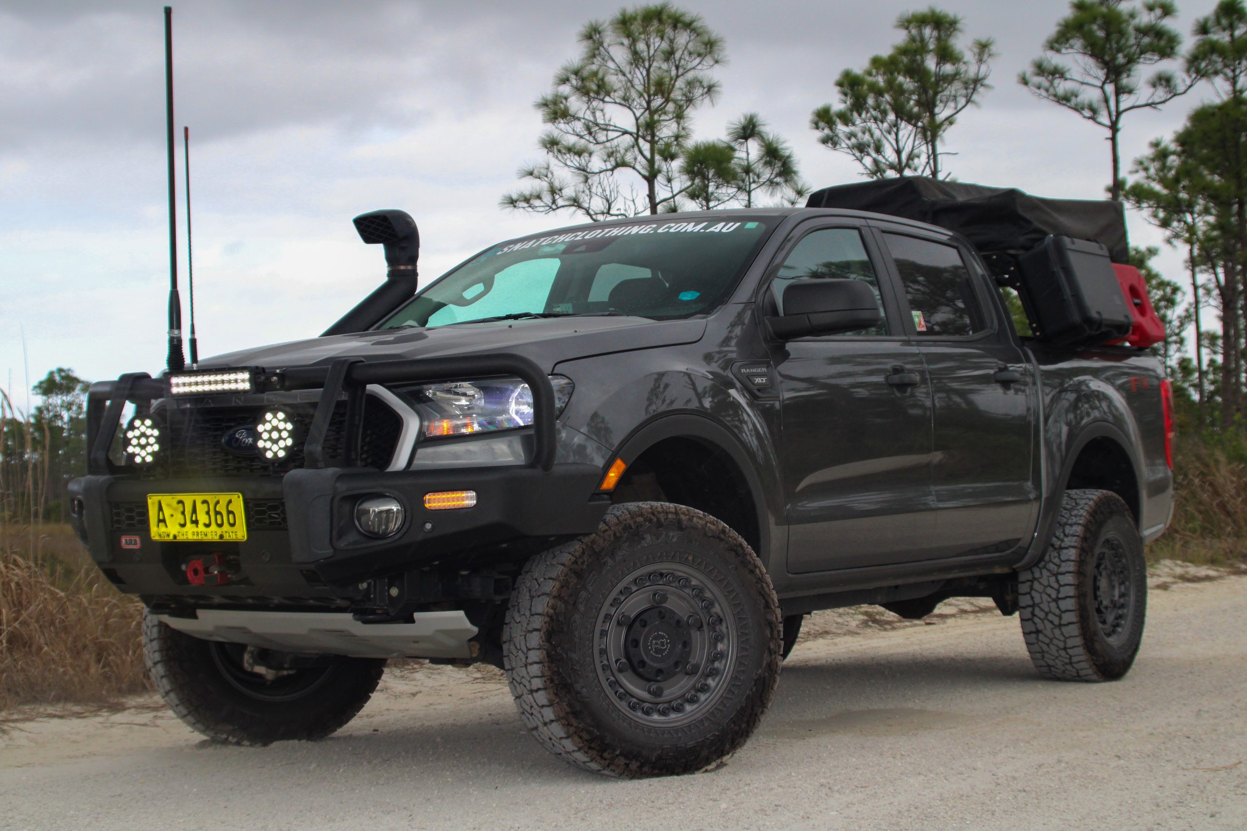 Gray Ford Ranger from the driver's side with front bumper, snorkel, and roof top tent.